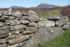 Drystone fank, with a builder's homage to Eabhal built into the base. Loch Faolin, Gramisdale, South Uist, September 2023